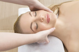 Woman getting a relaxing massage in a spa - head