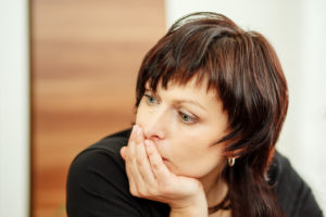 28790470 - beautiful middle age tired woman holding head, looking out